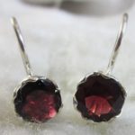 garnet earrings hooked on a silver caged setting JYHXPMQ