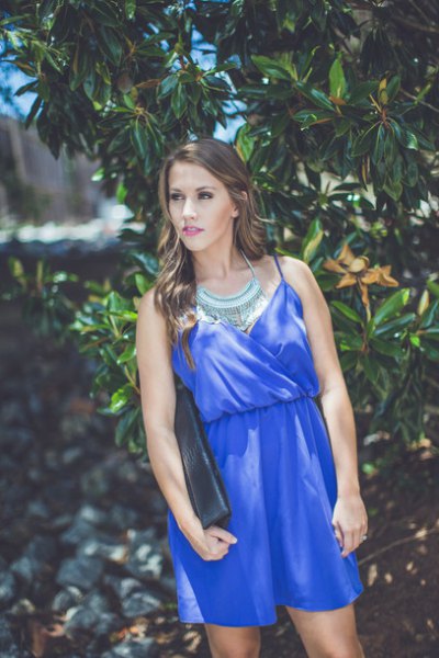 Royal blue mini dress with gathered waist and statement
necklace