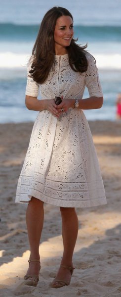 White crochet summer dress with a mid-length cut and a flared cut