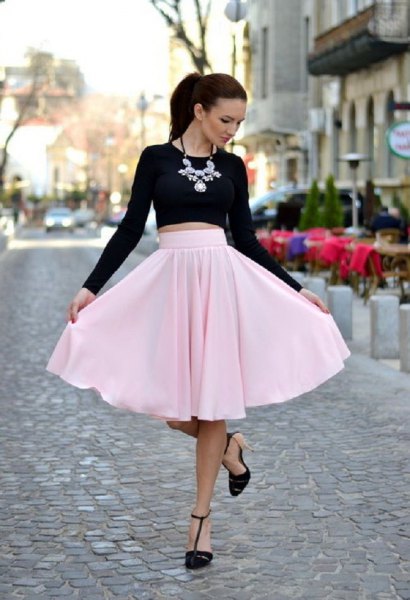 Black short sleeve t-shirt with light pink flared midi skirt