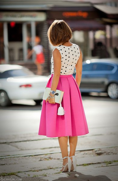 White and black polka dot sleeveless blouse with pink pleated midi skirt