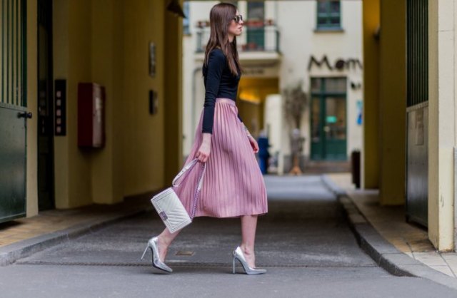 Black long-sleeved t-shirt with a pink flared midi pleated skirt