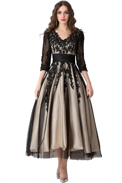 Black, semi-transparent, floor-length lace dress with three-quarter sleeves and a flared design and V-neckline