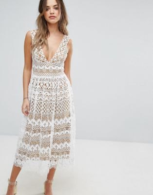 White lace midi dress with a deep V-neckline and a flared silhouette