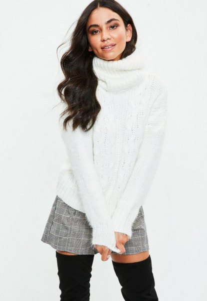 White cable knit turtleneck sweater and gray check mini
shorts