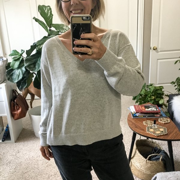 Gray cotton v-neck sweater and black straight-leg jeans