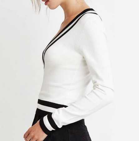 white sweater with black mini skater skirt