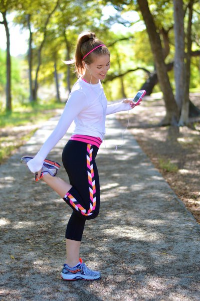 White long sleeve t-shirt with black and pink running shorts