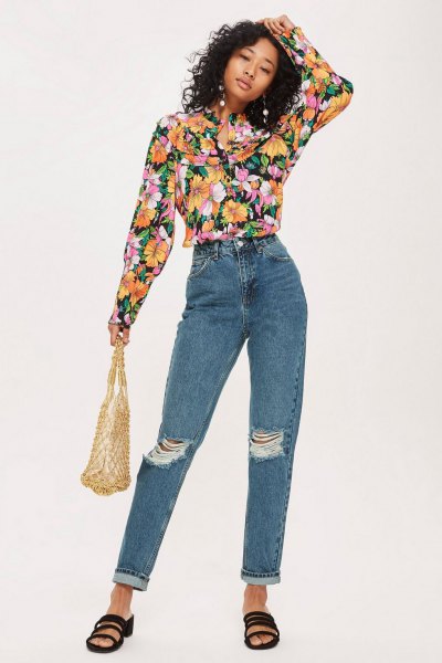 Black floral blouse and blue ripped jeans