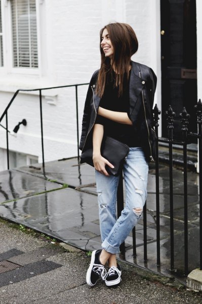 Black leather jacket with cuffed boyfriend jeans and clutch