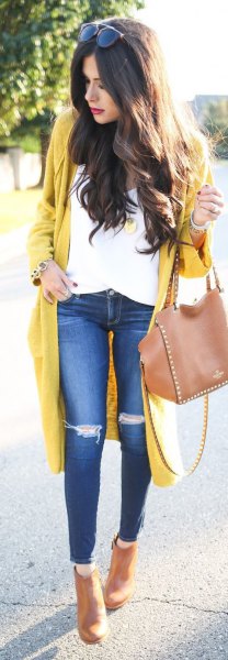 Yellow long cardigan sweater with white blouse and ripped knee jeans