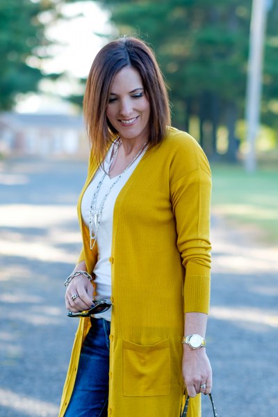 Mustard yellow cardigan with white scoop neck t-shirt and blue jeans