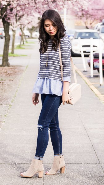 gray and white striped top over a light blue peplum blouse