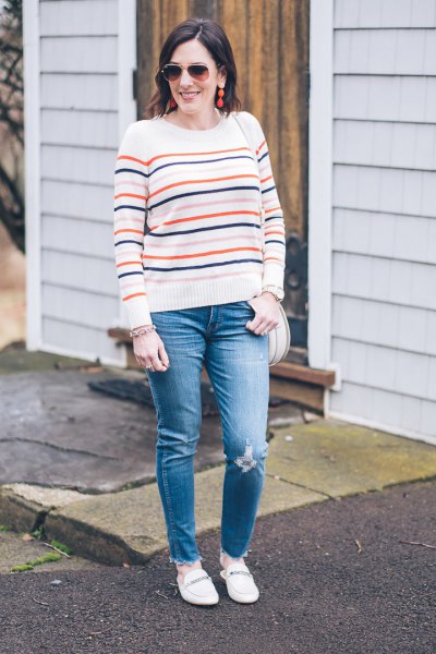 White knit sweater with blue jeans and loafers