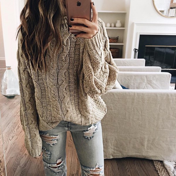 Gray cable knit sweater with ripped light blue skinny jeans