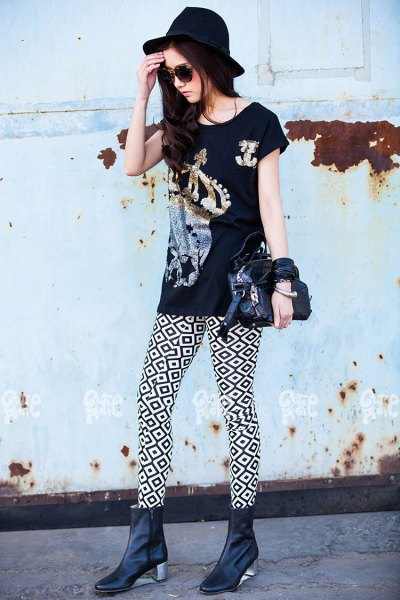 Black graphic t-shirt with high-heeled leather boots and felt hat