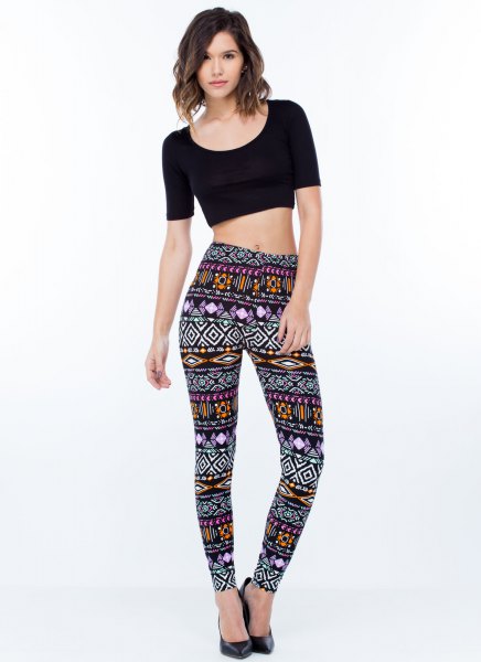 Black cropped t-shirt with high-waisted patterned leggings and heels