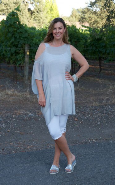 Light gray off-the-shoulder tunic blouse with silver slide sandals