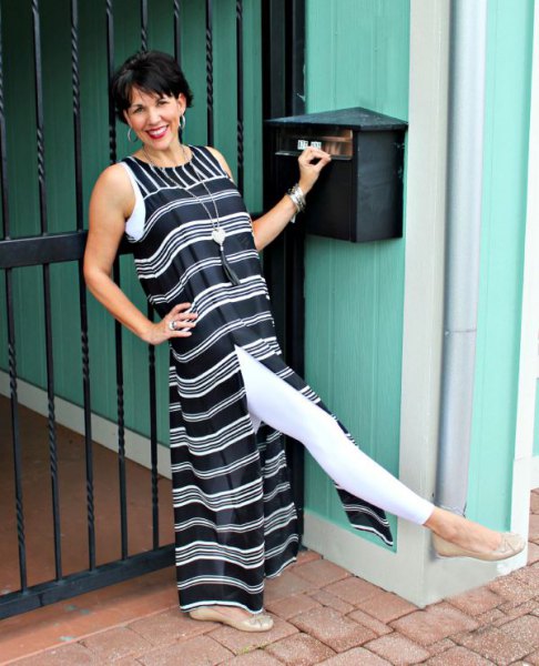 Black and white striped maxi dress with a high slit and leggings