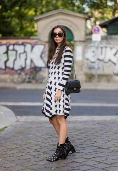 Black and white striped mini sheath dress with pointed leather ankle boots