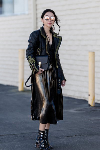 Black maxi jacket with pleated midi skirt and ankle boots with star studs