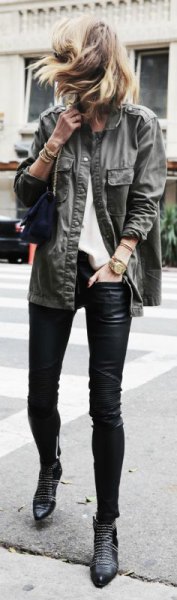 gray military jacket with black leather leggings and studded ankle boots