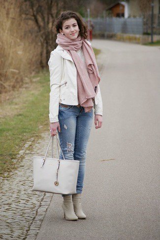 White leather blazer with blue jeans with cuffs and pink heeled
boots