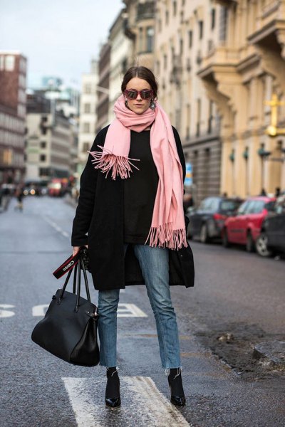 Black wool coat with pale pink fringed scarf and black cropped slim
fit jeans