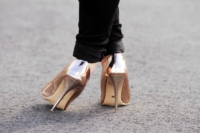 Black slim-fit jeans with cuffs and metallic gold heels