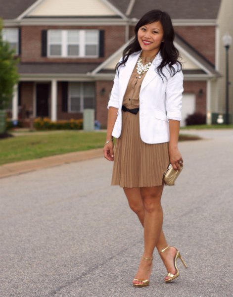 White blazer with pink pleated mini skirt and gold heels