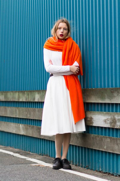 White sweater with matching flared midi skirt and orange long scarf