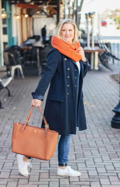 Navy blue long wool coat with jeans and white sneakers