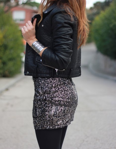 Black leather jacket with a fitted sequin mini skirt