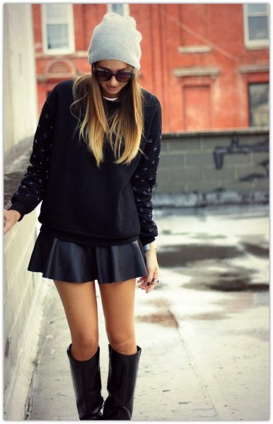 black chunky knit sweater with mini skater skirt and knee high boots