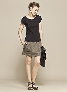 Black t-shirt with green mini cargo skirt and flat sandals