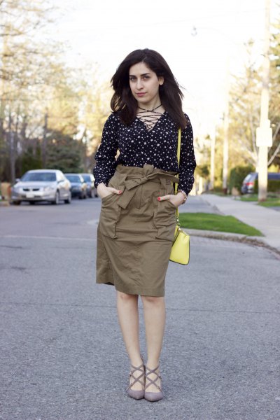 Black and white polka dot blouse with green high waisted cargo skirt