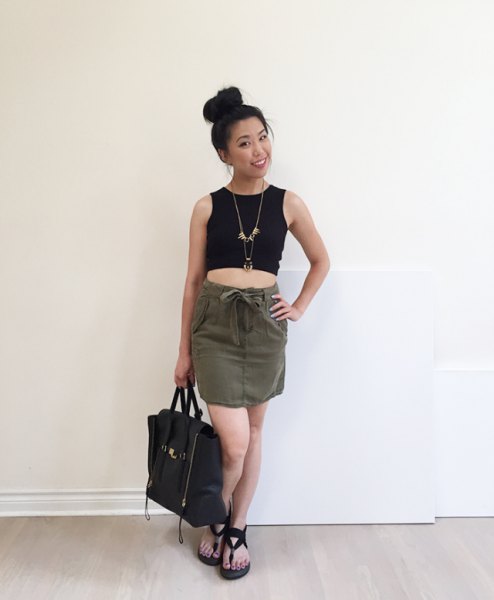 Black cropped tank top with a mini skirt that ties at the
waist