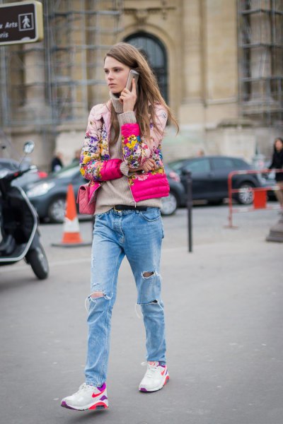 Pink floral bomber jacket paired with boyfriend jeans and white trail shoes