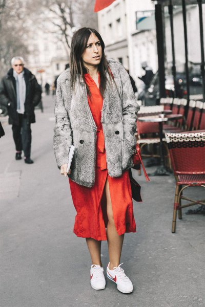 gray faux fur coat with orange midi dress and white tennis shoes