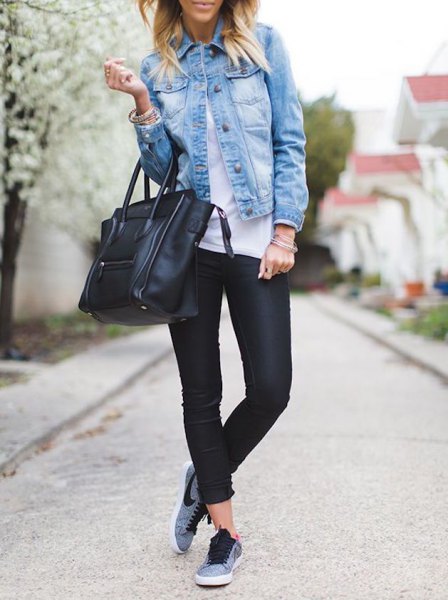 blue denim jacket with black leather trousers and gray tennis shoes
