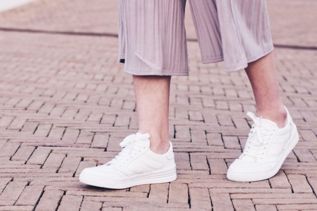 Gray striped chiffon wide leg pants and white sneakers