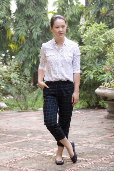 White printed blouse with dark green plaid ankle pants