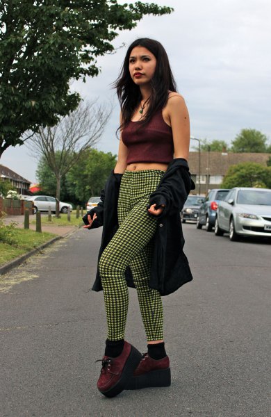 Black, short tank top with conspicuous green checked drainpipe trousers