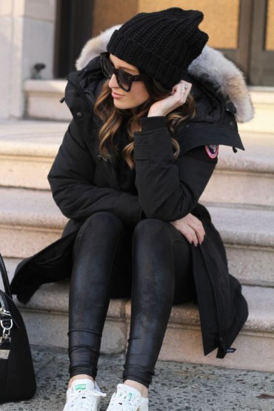 Long black parka jacket with a fur collar and leather leggings