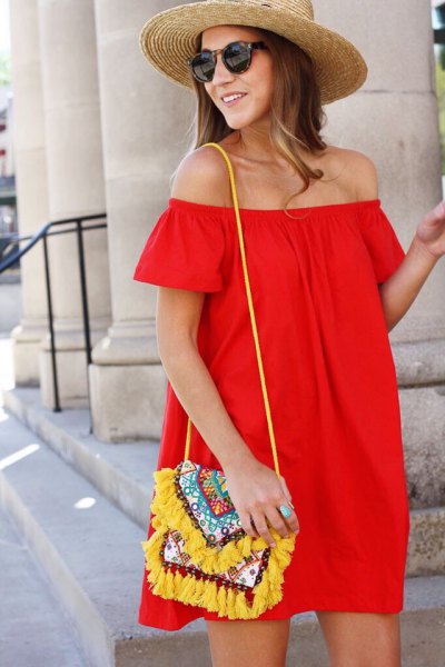 Red strapless shirt dress with a yellow handbag with a tribal pattern