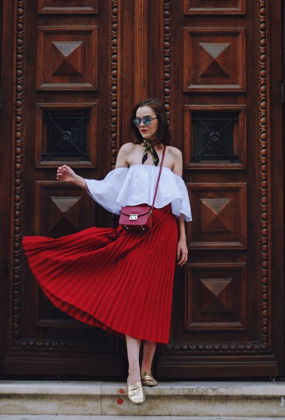 Light blue off-the-shoulder blouse with a red pleated midi skirt