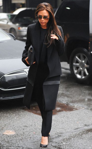 black long wool coat with chinos and leather clutch
