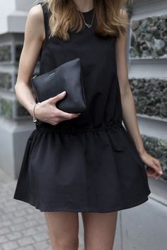 Black tank top with mini skater skirt and leather clutch