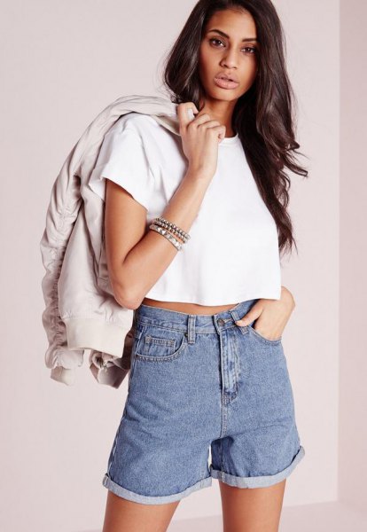 White cropped t-shirt with light pink bomber jacket and denim shorts
