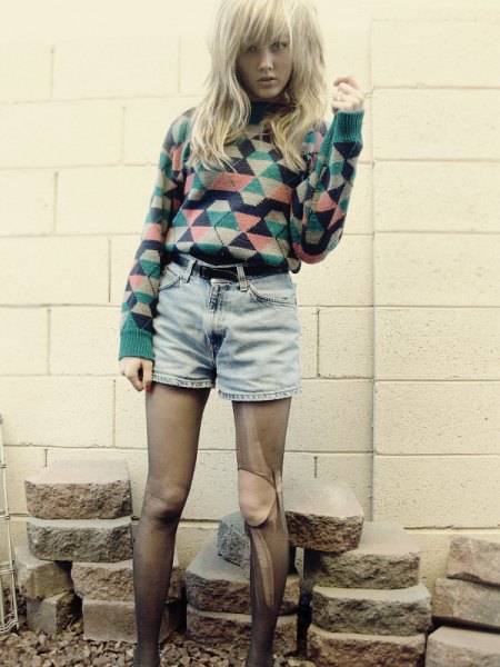 Rouge and black diamond patterned sweater with high waisted belted denim shorts
